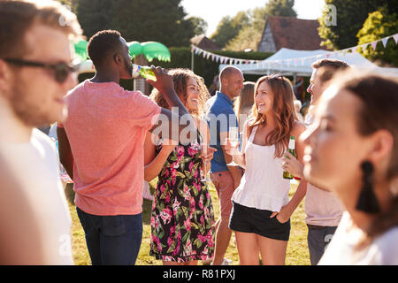 Group Of Friends Enjoying Drinks At Summer Garden Fete Stock Photo
