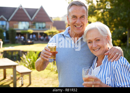 Portrait Of Senior Couple Enjoying Outdoor Summer Drink At Pub Stock Photo