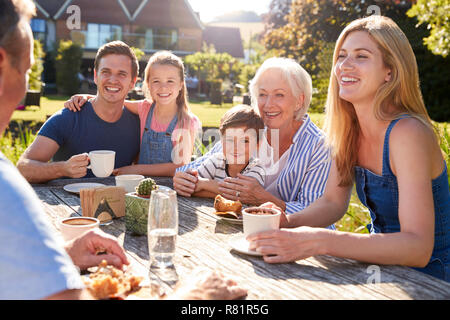 Multi Generation Family Sitting At Table Enjoying Outdoor Summer Drink At Cafe Stock Photo