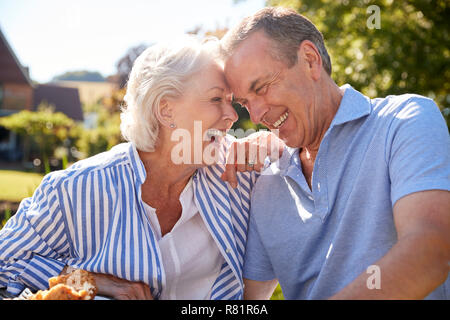 Senior Couple Enjoying Outdoor Summer Snack At Cafe Stock Photo