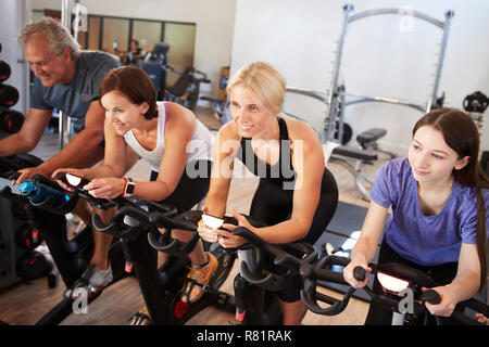 Group Taking Spin Class In Gym Stock Photo