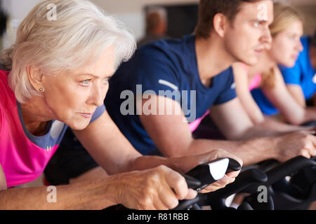 Close Up Of Group Taking Spin Class In Gym Stock Photo