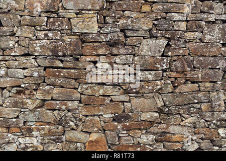 Stone wall background. Ancient wall of dry masonry. Stone wall texture in the historic city of Santiago de Compostela Stock Photo