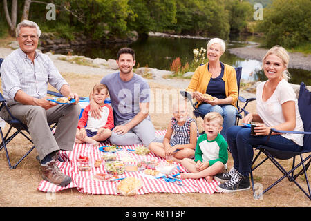 Portrait Of Multi Generation Family Enjoying Picnic In Countryside Stock Photo