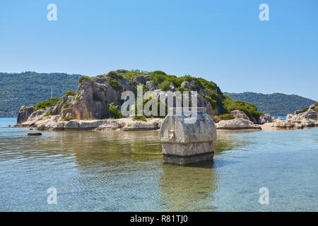 Coast of the island in the Mediterranean sea, picturesque with the ruins of ancient Lycian towns and tombs-sarcophagi of Aperlai, Simena Teimussa Doli Stock Photo