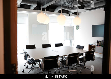 Chairs Around Boardroom Table In Empty Modern Meeting Room Stock Photo