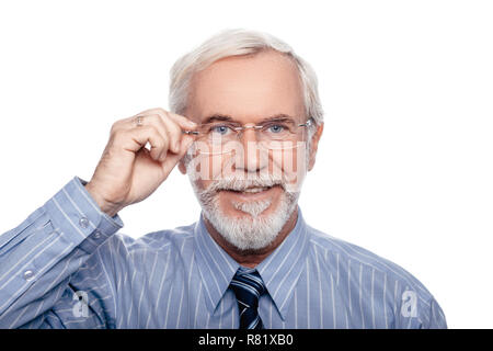 See the world better. Positive senior man ajusting his eyeglasses and looking at camera. Stock Photo