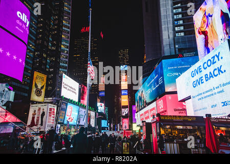 New York City: billboards light up Times Square NYC at night during the run-up to Christmas Stock Photo