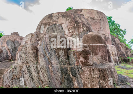 Big rock semi circle cut close front view at top of hills. Stock Photo