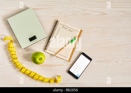 Diet and Healthy life Concept. Apple and Weight scale on white wooden background. top view and copy space. Stock Photo