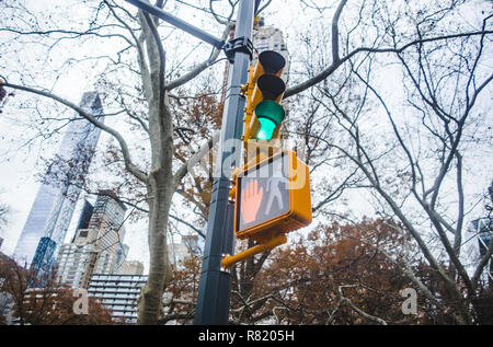 Green traffic light and red hand pedestrian stop sign at junction in New York City Stock Photo