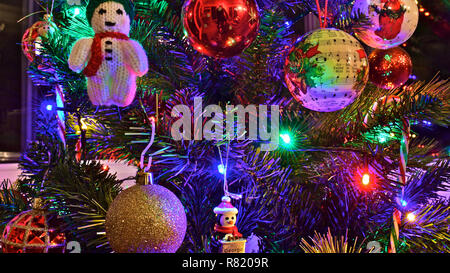 Brightly coloured Christmas tree decorations. Stock Photo