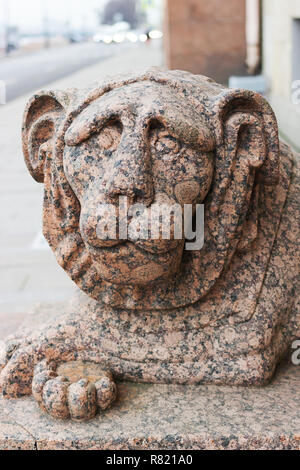 One of two granite lions at the entrance to the building of the Constitutional Court of the Russian Federation on English Embankment 4 in St. Petersbu Stock Photo