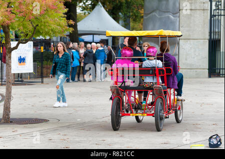 Portland, Oregon,USA - October 8, 2016:  Scene from along Portlands, Waterfront park where surrey bikes can be rented to travel along the sidewalk. Stock Photo