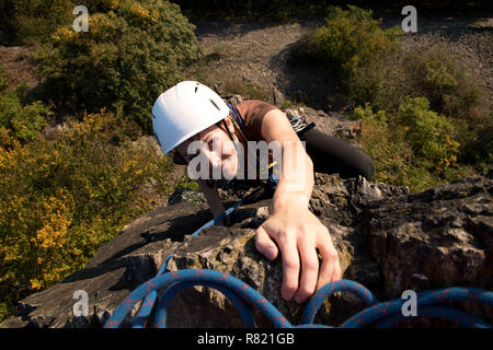 Young girl rockclimbing - reaching the summit, Pikovice, Czech republic Stock Photo