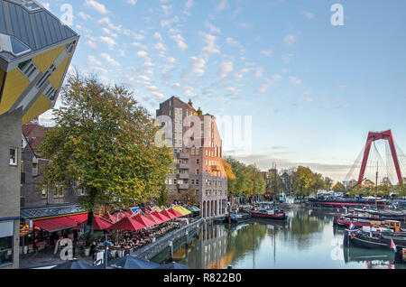 Rotterdam, The Netherlands, November 9, 2018: The Old Harbour, lined with outdoor cafes on the quay, with modern architecture including one of the Cub Stock Photo