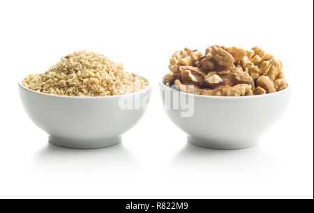 Milled and whole walnuts kernels in bowl isolated on white background. Stock Photo