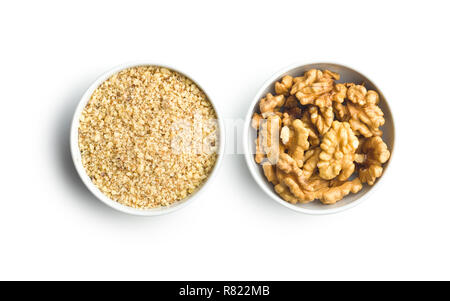Milled and whole walnuts kernels in bowl isolated on white background. Stock Photo