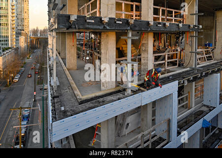 Building construction workers, Vancouver House,  Bjarke Ingels Group architects, Vancouver, British Columbia, Canada. Stock Photo