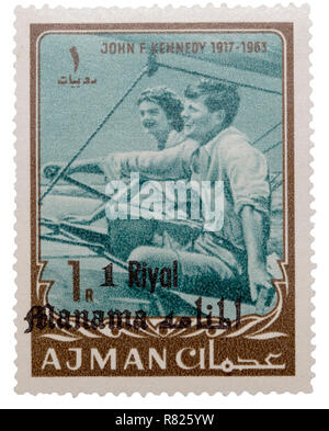 1 Riyal postage stamp with John F. Kennedy and Jacqueline Kennedy sailing, Ajman, United Arab Emirates Stock Photo