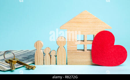 Family stands near the house. Affordable housing. Real estate concept. Buying and selling homes. Rent apartment. Sale of property. Mortgage and paymen Stock Photo