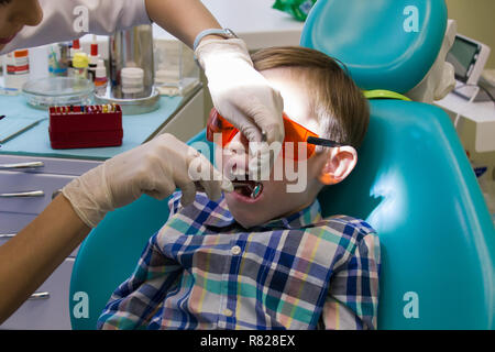 Reception at the dentistry. The dentist examines the oral cavity Stock Photo