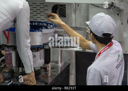 Bangkok, Thailand - November 21, 2018: Worker operate Dual motion parts feeder machine in Metalex 2018 Stock Photo