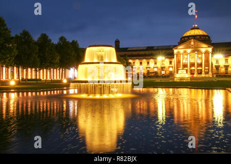 Kurhaus and Bowling Green in the evening with lights, Wiesbaden, Hesse, Germany. Wiesbaden is one of the oldest spa towns in Europe Stock Photo