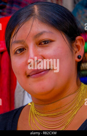 OTAVALO, ECUADOR, NOVEMBER 06, 2018: Portrait of indigenous woman wearing andean traditional clothing and necklace posing for camera Stock Photo