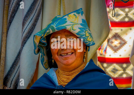 OTAVALO, ECUADOR, NOVEMBER 06, 2018: Portrait of smiling indigenous woman wearing andean traditional clothing, posing for camera Stock Photo