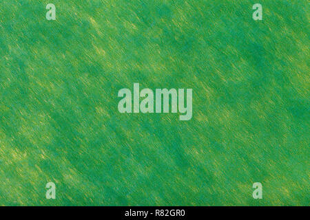 Construction of dark green background with light yellow spots of felt fabric, closeup. Texture of woolen fleecy matt textile. Cloth backdrop. Stock Photo