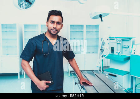 surgeon man relaxed smile confident in surgical room hospital, medical doctor wear green surgery scrub suit. Stock Photo