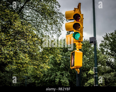 Yellow traffic light in New York City . Traffic light over the road in NYC showing a green light Stock Photo