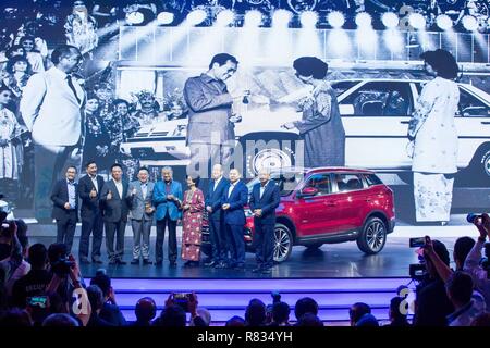 Kuala Lumpur, Malaysia. 12th Dec, 2018. Malaysian Prime Minister Mahathir Mohamad (5th R) and his wife Siti Hasmah Mohamad Ali (4th R) pose for photos with guests and Proton officials during the official launching ceremony of Proton's SUV X70 in Kuala Lumpur, Malaysia, Dec. 12, 2018. Malaysian national car manufacturer Proton and China's Geely have unveiled their first joint commercial product on Wednesday with the launch of the X70 sports utility vehicle (SUV). Credit: Zhu Wei/Xinhua/Alamy Live News Stock Photo