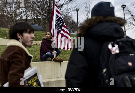 Columbus, Ohio, USA. 12th Dec, 2018. A woman seen seating with a flag during the protest.Protesters marched to the Ohio State House in Columbus, Ohio to protest the controversial Heartbeat Bill or HB258, which bans abortion once a fetal heartbeat is detected. The bill would make it much more difficult for women to seek an abortion in the state of Ohio. The bill was passed by members of the Ohio Senate with a vote of 18-13. Credit: ZUMA Press, Inc./Alamy Live News Stock Photo