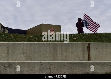 Columbus, Ohio, USA. 12th Dec, 2018. A protester seen holding a flag during the protest.Protesters marched to the Ohio State House in Columbus, Ohio to protest the controversial Heartbeat Bill or HB258, which bans abortion once a fetal heartbeat is detected. The bill would make it much more difficult for women to seek an abortion in the state of Ohio. The bill was passed by members of the Ohio Senate with a vote of 18-13. Credit: ZUMA Press, Inc./Alamy Live News Stock Photo