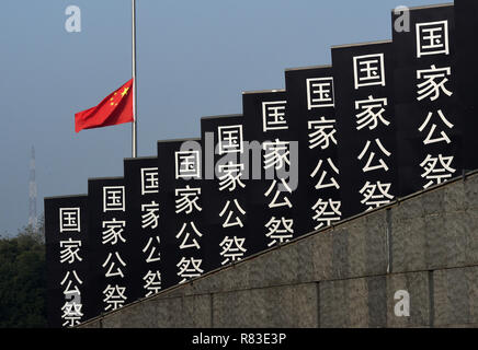 Nanjing, China's Jiangsu Province. 13th Dec, 2018. China's national flag flies at half mast during the state memorial ceremony for China's National Memorial Day for Nanjing Massacre Victims at the memorial hall for the massacre victims in Nanjing, capital of east China's Jiangsu Province, Dec. 13, 2018. Credit: Sun Can/Xinhua/Alamy Live News Stock Photo
