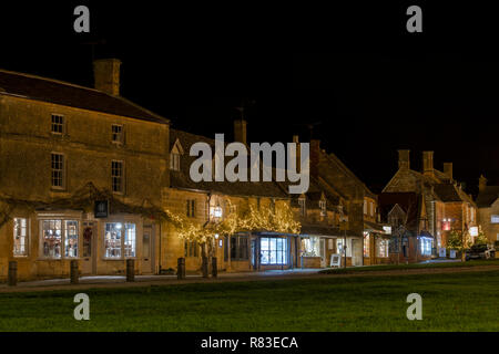 Broadway shops on the high street in december at night. Broadway, Cotswolds, Worcestershire, England Stock Photo