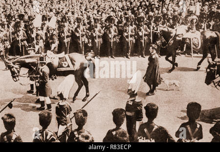 King Edward VII's favourite dog, Caesar, following the king's charger (horse) during Edward's funeral on the morning of 17 May 1910. His coffin was placed on a gun carriage and drawn by black horses to Westminster Hall, with the new King (George V) and his family walking behind. Following a brief service, the royal family left, and the hall was opened to the public; over 400,000 people filed past the coffin over the next two days. Stock Photo