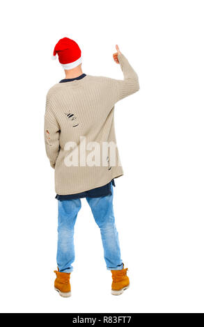 Back view of a man wearing a Santa Claus hat showing his thumb up. Rear view people collection.  backside view of person.  Isolated over white backgro Stock Photo