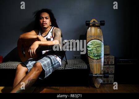 ANTIPOLO CITY, PHILIPPINES - DECEMBER 10, 2018: A Filipino musician with an acoustic guitar pose for the camera. Stock Photo