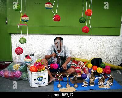 ANTIPOLO CITY, PHILIPPINES - DECEMBER 8, 2018: A street vendor sells hand crafted lamp shades on a sidewalk. Stock Photo