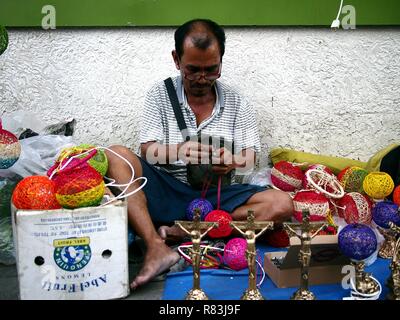 ANTIPOLO CITY, PHILIPPINES - DECEMBER 8, 2018: A street vendor sells hand crafted lamp shades on a sidewalk. Stock Photo