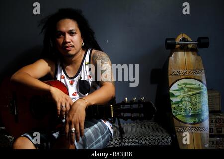 ANTIPOLO CITY, PHILIPPINES - DECEMBER 10, 2018: A Filipino musician with an acoustic guitar pose for the camera. Stock Photo