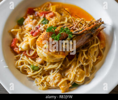 spaghetti with tiger prawn sauteed with shrimp oil in a plate Stock Photo