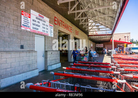 August 6, 2018 Mountain View / CA / USA - Entrance to one of the Costco Wholesale shop in south San Francisco bay area; stores hours displayed on the  Stock Photo