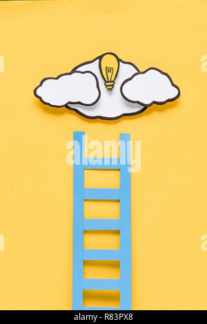 cardboard ladder with light bulb and clouds on yellow background, ideas concept Stock Photo