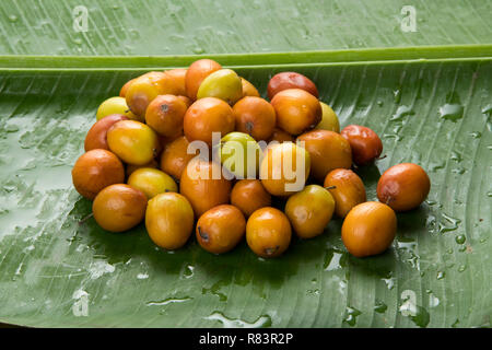 Fruit : Close up of Indian Jujube Apples Isolated on Green Banana Leaf Background Shot in Studio Stock Photo