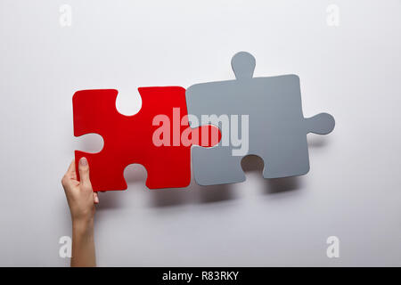 top view of red and grey puzzles problem solution symbol on grey background Stock Photo