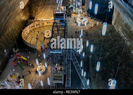 Turda, Romania - July 28, 2018: Tourists enjoying the underground amusement park in the salt mine of Turda, Romania Stock Photo